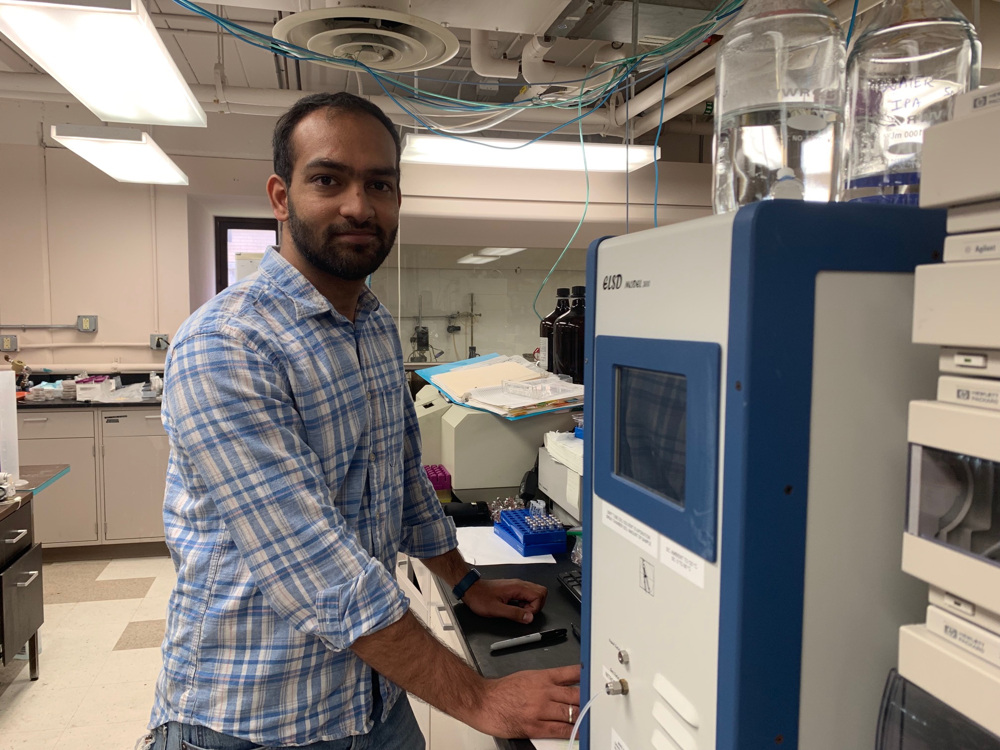Ashwin Sancheti using the high-performance liquid chromatography machine for his research on soy molasses.